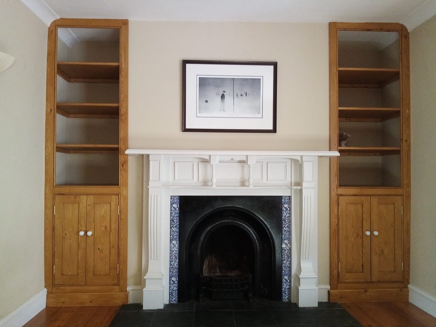 Built-in cabinets beside a fireplace